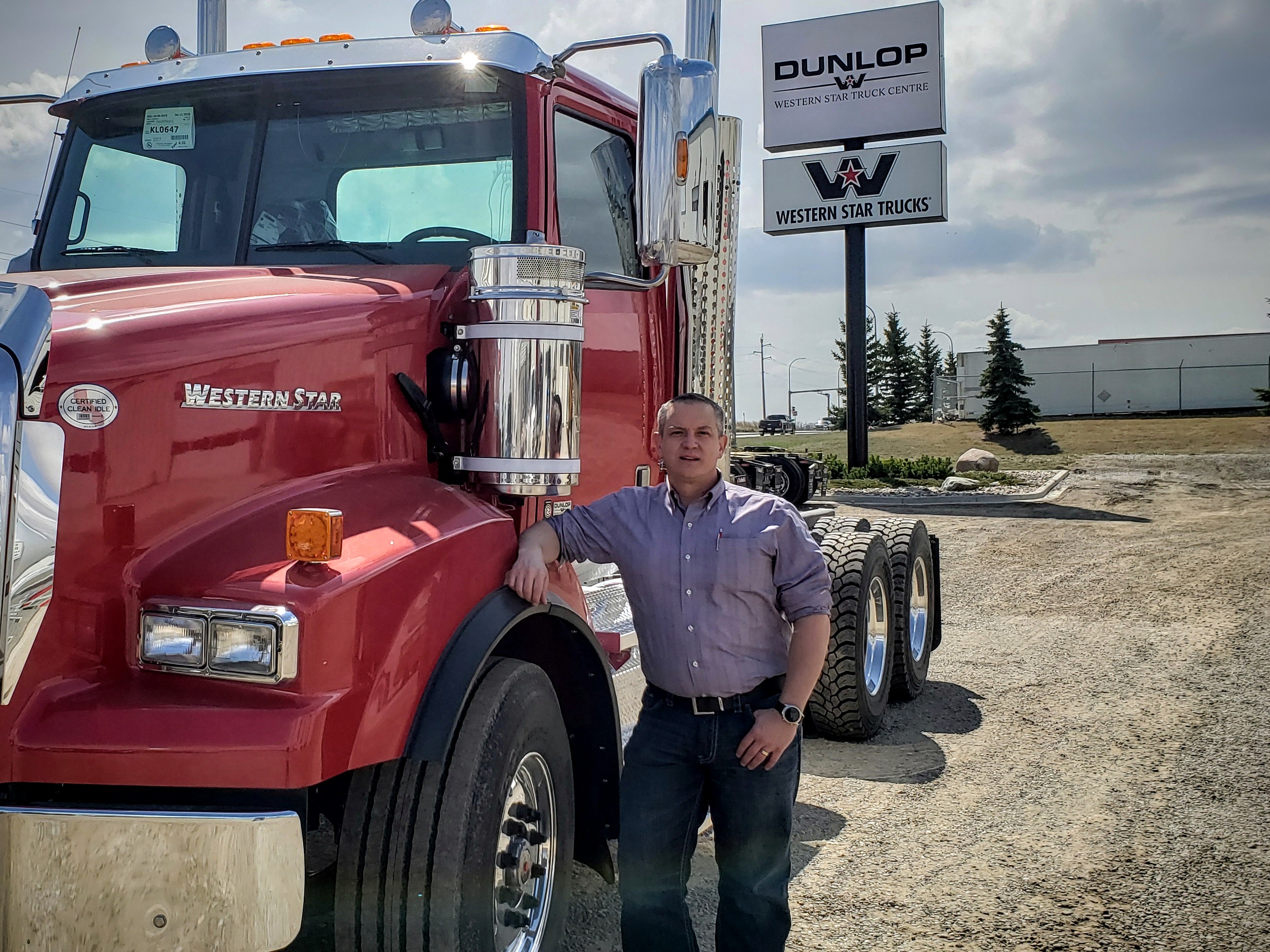 Chris Thom standing next to a Western Star truck.